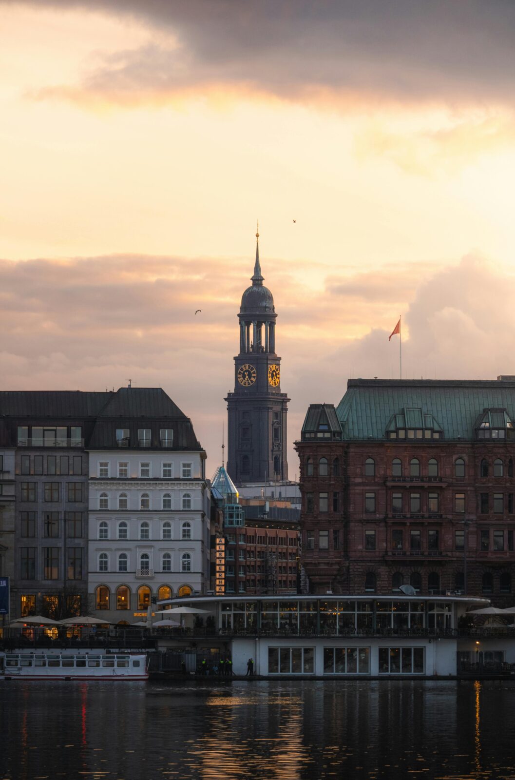 Scenic view of St. Michael's Church tower in Hamburg, highlighted against a sunset sky.